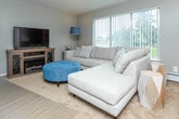 Located at 19345 Gaynon Dr in Clinton Township, Michigan, this two-floor home offers a comfortable and functional layout designed for everyday living. The living room serves as the heart of the main floor, featuring soft wall-to-wall carpeting, a large picture window with vertical blinds that invite natural light, and a media console housing a built-in electric fireplace — a practical and inviting focal point for the space. The kitchen is efficiently arranged with white cabinetry, a coil-burner electric range, over-the-range microwave, and a full-size refrigerator, providing all the essentials in a clean, compact workspace. The full bathroom features tile flooring, white cabinetry with a stone-patterned countertop, and a tub-shower combination. The bedrooms are carpeted and bright, each equipped with ceiling fans and windows that bring in natural light. The primary bedroom offers a cozy, neutral palette with ample storage, while a secondary bedroom accommodates flexible sleeping arrangements with bunk bed and futon setups. Additional bedrooms mirror the home's consistent use of light tones, carpet, and baseboard heating, maintaining a cohesive and practical atmosphere throughout both floors.
