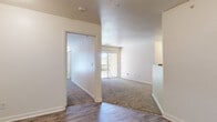 Located at 15526 W 133rd St in Olathe, Kansas, this single-floor, 3-bedroom, 2-bathroom home offers a well-organized layout designed for comfortable everyday living. The combined kitchen and living room serves as the heart of the home, with the kitchen featuring warm oak cabinetry, granite-look countertops, wood-look plank flooring, and white appliances including a refrigerator and electric range. The living room flows naturally from the kitchen area and is carpeted for comfort, with a standout sliding glass door that opens to a private balcony overlooking lush greenery—bringing in generous natural light and peaceful outdoor views. The three bedrooms are finished with plush carpeting and neutral tones, creating a calm and restful atmosphere. The primary bedroom includes two closets, providing ample storage. Additional bedrooms feature windows that allow natural light to filter in. Both bathrooms are outfitted with wood-look tile flooring, vanities with storage, and full tub-shower combinations. Two dedicated closets throughout the home add practical storage. The clean, neutral color palette and consistent finishes throughout give this home a cohesive and move-in-ready feel.