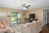 Located at 31 Trillium Cir in Dothan, Alabama, this 2-bedroom, 2-bathroom single-floor residence offers a well-organized and comfortable layout. The living room serves as the heart of the home, featuring wood-look flooring, a ceiling fan, and a sliding glass door with vertical blinds that fills the space with natural light and provides views of the surrounding greenery outside. The adjoining dining area is a defined space with warm neutral walls and a textured ceiling, ideal for everyday meals. The galley-style kitchen is efficiently designed with rich dark cabinetry, light countertops, wood-look flooring, and black appliances including a range and refrigerator, offering ample storage and prep space. The primary bedroom is generously sized with plush carpeting, a window with natural light, and access to a closet. The second bedroom is similarly comfortable and carpeted. Both bathrooms are clean and functional, featuring neutral tones and wood-look flooring. A dedicated in-unit laundry room accommodates a full-size washer and dryer with overhead shelving for added convenience. Throughout, the home maintains a cohesive warm neutral palette with textured ceilings, creating a welcoming and practical living environment.