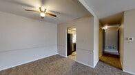 Located at 2122 E Bristol St in Elkhart, Indiana, this single-floor, 3-bedroom, 1-bathroom unit offers a straightforward and functional layout. The living area is generously sized, featuring neutral beige walls, wall-to-wall carpeting, a ceiling fan, and a sliding glass door that invites natural light and provides outdoor access. A central hallway connects the main living space to the three bedrooms, each finished with plush carpeting and windows that allow natural light to fill the rooms. The spacious primary bedroom offers ample floor area for comfortable furnishing. The kitchen features light wood cabinetry, a black gas range, and tile flooring, creating a clean and practical cooking space that opens conveniently toward the living and dining areas. The full bathroom includes a vanity with a marble-patterned countertop, a large mirror with Hollywood-style lighting, and tile flooring. A dedicated closet provides additional storage. Throughout the unit, a consistent warm neutral color palette and clean white trim contribute to a cohesive and welcoming atmosphere. The layout is designed for efficient use of space, making it a practical and comfortable option in the Elkhart area.