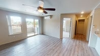 Located at 2530 SW Cherry Park Rd in Troutdale, Oregon, this single-floor residence offers a thoughtfully designed layout that balances comfort and functionality. The open-concept living area is finished with light wood-style flooring, a ceiling fan, and a wall-mounted mini-split HVAC unit, providing year-round climate control. Sliding glass doors lead directly to a private balcony, bringing in generous natural light and outdoor views of the surrounding neighborhood. An electric fireplace adds a cozy focal point to the living space.

The kitchen is well-equipped and features warm honey-toned cabinetry, granite-look countertops, a peninsula with a breakfast bar, and a full suite of stainless steel appliances including a refrigerator, electric range, and over-the-range microwave. Recessed lighting illuminates the space efficiently.

The bedrooms are carpeted for comfort and benefit from multiple windows that invite natural light. Each bedroom includes closet space for convenient storage. The bathroom is clean and functional, offering a full soaking tub and shower combination with crisp white surrounds. The overall palette throughout is neutral and modern, creating a bright, move-in-ready atmosphere.