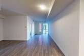 This contemporary 540 square foot apartment in Toronto offers a thoughtful layout maximizing space and functionality. The open-concept design seamlessly integrates the living room and kitchen, creating a spacious feel. The kitchen boasts modern white cabinetry, stainless steel appliances, and a compact yet efficient design.

Large windows flood the space with natural light and provide urban views, enhancing the apartment's airy ambiance. The hardwood floors throughout add warmth and continuity to the space. The bedroom, while compact at 100 square feet, features a mirrored closet to maximize storage and visual space.

The bathroom is well-appointed with neutral tiling, a vanity with storage, and a shower/tub combination. Recessed lighting and strategically placed fixtures ensure the space is well-lit. The apartment's clean lines, neutral color palette, and modern finishes create a stylish and inviting urban retreat, ideal for contemporary city living.