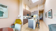 Located at 202 Salter St in New Westminster, BC, this well-appointed 2-bedroom, 2-bathroom home offers a thoughtfully designed single-floor layout with an impressive sense of space and light throughout. The kitchen is a standout feature, boasting soaring ceilings with a skylight, sleek wood-grain cabinetry extending to the ceiling, granite countertops, stainless steel appliances, and a central island with bar seating — all complemented by light hardwood flooring that flows throughout the home. The open dining area is bathed in natural light from large windows that frame panoramic views of the Fraser River and the New Westminster skyline, making it an ideal space for meals with a view. The living room is bright and inviting, featuring a fireplace, floor-to-ceiling windows, and direct access to the private balcony. The generously sized primary bedroom includes a walk-in closet and large windows overlooking lush greenery. The second bedroom is cozy and bright, with a large window providing serene treetop views. Both bathrooms are finished with granite vanities and wood-grain cabinetry, with one featuring a full tub and brown tile surround. Ample closet space is found throughout the home, and a hallway connects all rooms efficiently.