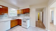 Located in Eagle Rock Village in Budd Lake, NJ, this one-bedroom, one-bathroom residence offers a practical and well-organized single-floor layout. The kitchen is equipped with warm oak cabinetry, a mosaic tile backsplash, light stone-look tile flooring, and white appliances including a range, dishwasher, and refrigerator, along with a window that brings in natural light. The kitchen flows into a dedicated dining area and connects seamlessly to the rest of the unit. The living room features light hardwood flooring, recessed lighting, and a sliding glass door that opens onto a private balcony, allowing for outdoor views and additional natural light. The bedroom is a comfortable size, finished with the same hardwood flooring, a window overlooking greenery, and access to a spacious walk-in closet with built-in shelving and hanging rods. A second closet provides additional storage. The bathroom is appointed with classic subway tile walls, marble-look tile flooring, a soaking tub with shower, a vanity with sink, and a window for ventilation and natural light. Neutral, warm tones are carried throughout the unit, creating a cohesive and inviting ambiance well-suited for comfortable everyday living.