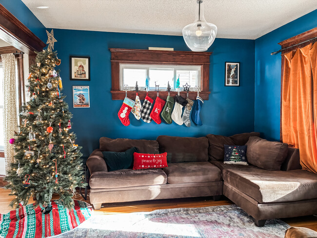 Main floor living area with beautifully maintained woodwork and a leaded glass window. - 819 Edmund Ave