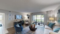 Located in Royal Palm Beach, FL, this well-appointed 2-bedroom, 2-bathroom single-floor residence offers a thoughtfully designed layout with a welcoming, cohesive flow throughout. The living room is bright and open, featuring wood-style flooring, a textured ceiling, and a wall of sliding glass doors that lead to a screened balcony overlooking lush greenery and mature palm trees — an ideal spot for relaxing outdoors. The adjacent dining area connects seamlessly to the kitchen, which is equipped with dark granite countertops, white shaker-style cabinetry, a subway tile backsplash, stainless steel appliances, and tile flooring. A dedicated dining space with wood-style floors provides a defined area for meals. The spacious primary bedroom features plush carpet, a ceiling fan, and large windows that fill the room with natural light, complemented by a generous walk-in closet with built-in shelving and drawers. The second bedroom is equally comfortable, and both bathrooms offer tub-shower combinations with clean, classic tile finishes and updated vanities. A dedicated in-unit laundry room houses a full-size washer and dryer with overhead shelving. Three total closets provide ample storage throughout.