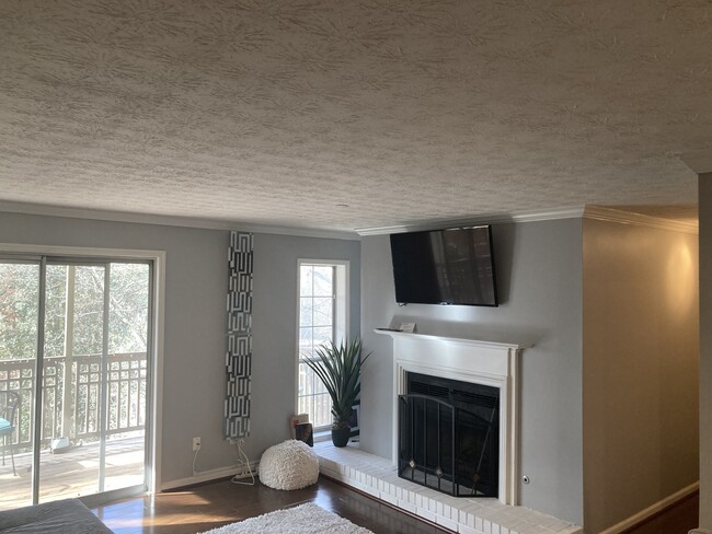Large living area with fireplace and gorgeous view into the creek. - 2901 Lenox Rd NE