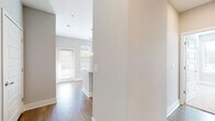 This single-floor residence offers a thoughtfully designed layout with modern finishes throughout. The open-concept kitchen serves as a central highlight, featuring a large island with granite countertops, an undermount sink, and sleek pendant lighting overhead. Light wood-tone cabinetry extends to the ceiling, providing ample storage, while stainless steel appliances — including a gas range, microwave, dishwasher, and refrigerator — complete the space. A white subway tile backsplash adds a clean, contemporary touch, and light hardwood-style flooring ties the kitchen and adjacent living areas together seamlessly. Multiple windows allow generous natural light to fill the space.

The bedrooms are carpeted and outfitted with ceiling fans, offering a comfortable, quiet retreat. One bedroom benefits from natural light via dual windows. A spacious walk-in closet features multi-tier wire shelving along two walls, providing substantial organization capacity.

Two bathrooms are present: a full bathroom with a dual-sink vanity topped with granite, a soaking tub with tiled surround, and direct access to a shelved linen closet; and a secondary bathroom with a single granite-topped vanity and hardwood-style flooring. Both bathrooms feature modern cabinetry consistent with the home's overall design aesthetic.