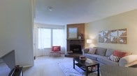 Located at 3300 West Dublin Granville Road in Columbus, Ohio, this two-floor residence offers a welcoming and well-appointed living environment. The living room serves as the heart of the home, centered around a classic corner brick fireplace framed by warm wood paneling and topped with a decorative mirror — a standout architectural detail that adds character and charm to the space. Large windows dressed with sheer white curtains flood the room with natural light, creating a bright and airy atmosphere. The carpeted flooring adds warmth underfoot, and the generous layout comfortably accommodates a full seating arrangement, making it ideal for both relaxing and entertaining. Neutral wall tones throughout lend a clean, versatile backdrop that complements a range of décor styles. The two-floor layout provides a natural separation between living and private spaces, offering both functionality and comfort. Situated in the northwest Columbus area, the property benefits from convenient access to the amenities and services along the Dublin Granville Road corridor, making it a practical and inviting place to call home.