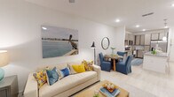 This one-bedroom, one-bathroom residence in Parker, Florida is designed with a bright, open-concept layout that seamlessly connects the kitchen, dining, and living areas. Light wood-look flooring flows throughout the main living spaces, complementing the clean white walls and recessed lighting that give the unit an airy, modern feel.

The kitchen is a standout feature, outfitted with light wood cabinetry extending to the ceiling for ample storage, granite countertops, a classic subway tile backsplash, and a full suite of stainless steel appliances including a refrigerator with ice maker, electric range, microwave, and dishwasher. A peninsula with pendant lighting and seating provides both additional prep space and a casual dining option.

The living area is generously proportioned, featuring a ceiling fan and windows that invite natural light. A dedicated dining space sits adjacent, offering a natural transition between the kitchen and lounge areas.

The bedroom is carpeted and tranquil, with a ceiling fan, a window with blinds, and access to a walk-in closet with wire shelving. The full bathroom includes a granite vanity, wood-toned cabinetry, and a tub-shower combination. A dedicated in-unit laundry room houses a full-size washer and dryer, adding everyday convenience to this well-appointed home.