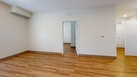 Located in Wichita, KS (67206), this single-floor, 2-bedroom, 2-bathroom residence offers a clean, modern design with a functional and efficient layout. Warm wood-look flooring flows consistently throughout the entire space, creating a cohesive and inviting atmosphere.

The kitchen is well-equipped with rich, medium-toned cabinetry, light stone countertops, and stainless steel appliances, including a refrigerator, electric range, and over-the-range microwave. The adjoining living room provides an open connection to the kitchen and features neutral walls that maximize the sense of space and light.

The primary bedroom is a comfortable, well-proportioned room featuring French doors that lead to a private outdoor area, allowing for ample natural light. The second bedroom offers a bright, clean space with a window fitted with blinds. Both bedrooms share access to two full bathrooms, each outfitted with a tub/shower combination, curved curtain rod, and grab bar for added accessibility. The flooring in the bathrooms continues the wood-look theme seen throughout the home.

A central hallway connects the bedrooms and bathrooms, contributing to a logical and easy-to-navigate floor plan. The overall ambiance of the residence is clean, neutral, and move-in ready.