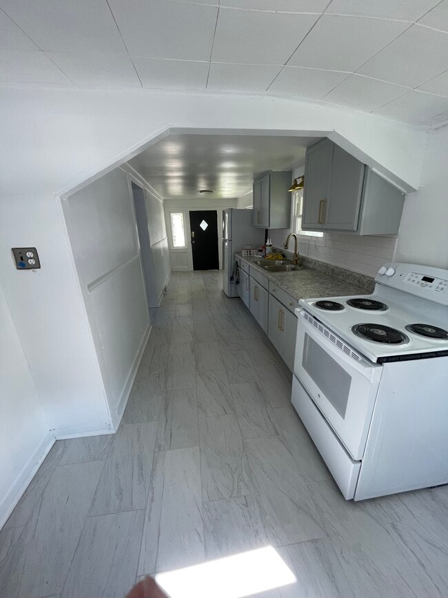 Kitchen. Newly renovated complete with new flooring, appliances, cabinets, and paint. - 106 Water St