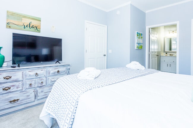 Smart TVs in two bedrooms and main living area with access to streaming networks - 106 W Arctic Ave