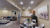 This single-story, 2-bedroom, 2-bathroom residence in Flagstaff, Arizona offers a thoughtfully organized layout that maximizes its living space. The open-concept design connects the living, dining, and kitchen areas into one cohesive common space. The living room features plush carpeting, a ceiling fan, a tile-surround fireplace, and a sliding glass door that introduces natural light and outdoor access. Recessed lighting throughout the common areas provides consistent, even illumination.

The kitchen is efficiently designed with warm-toned wood cabinetry, tile flooring, a double sink, and a full suite of white appliances, including a refrigerator, range, microwave, and dishwasher. A breakfast bar separates the kitchen from the dining area, which comfortably accommodates a full dining table.

Both bedrooms are carpeted and feature ceiling fans, window blinds, and ample natural light. The primary bedroom is notably spacious with multiple windows. Each bedroom is served by its own full bathroom, both featuring wood vanity cabinetry, countertop sinks, large mirrors, tile flooring, and a tub-shower combination, providing practical functionality for everyday living.