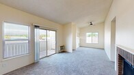 Located at 6615 Delmonico Dr in Colorado Springs, CO, this two-bedroom, two-bathroom single-floor residence offers a practical and comfortable layout across a well-utilized footprint. The combined kitchen and living area serves as the heart of the home. The living room features plush carpeting, a textured ceiling, a ceiling fan, and a charming brick fireplace that adds warmth and character. A sliding glass door opens to a private balcony, filling the space with natural light and outdoor views of the surrounding Colorado landscape. The galley-style kitchen is efficiently designed with warm wood cabinetry, light countertops, a stainless steel sink, and stainless appliances including a refrigerator and range, all complemented by light wood-look flooring and a window for natural light. Both bedrooms are carpeted and well-sized, each featuring sliding-door closets and windows. The primary bedroom also includes direct balcony access via a sliding glass door. The two bathrooms are clean and functional, each offering a tub-shower combination, with one featuring a wood-toned vanity with a mirrored medicine cabinet. A dedicated laundry area with overhead cabinetry and washer/dryer hookups adds everyday convenience to this well-rounded Colorado Springs residence.