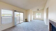 Located at 6615 Delmonico Dr in Colorado Springs, CO, this two-bedroom, two-bathroom single-floor residence offers a practical and comfortable layout across a well-utilized footprint. The combined kitchen and living area serves as the heart of the home. The living room features plush carpeting, a textured ceiling, a ceiling fan, and a charming brick fireplace that adds warmth and character. A sliding glass door opens to a private balcony, filling the space with natural light and outdoor views of the surrounding Colorado landscape. The galley-style kitchen is efficiently designed with warm wood cabinetry, light countertops, a stainless steel sink, and stainless appliances including a refrigerator and range, all complemented by light wood-look flooring and a window for natural light. Both bedrooms are carpeted and well-sized, each featuring sliding-door closets and windows. The primary bedroom also includes direct balcony access via a sliding glass door. The two bathrooms are clean and functional, each offering a tub-shower combination, with one featuring a wood-toned vanity with a mirrored medicine cabinet. A dedicated laundry area with overhead cabinetry and washer/dryer hookups adds everyday convenience to this well-rounded Colorado Springs residence.