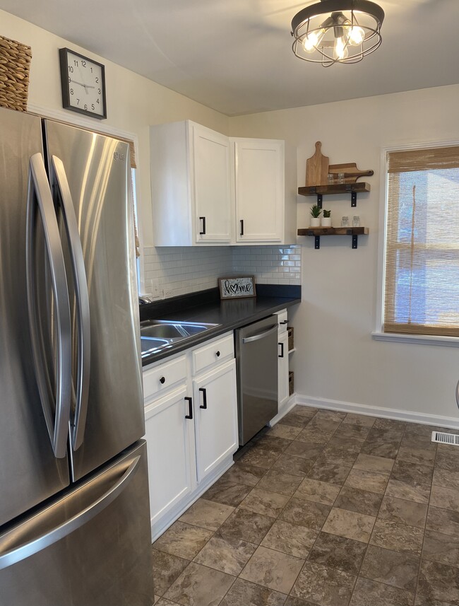 New subway tile backsplash, along with freshly painted cabinets and under cabinet lighting. - 4651 Luann Ave