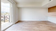 Located in Los Angeles, CA, this thoughtfully designed 2-bedroom, 2-bathroom residence offers a clean, modern aesthetic throughout. Light wood-style flooring flows seamlessly across the entire single-level layout, complementing the crisp white walls and creating a bright, cohesive atmosphere.

The combined dining and living area provides a comfortable, open gathering space anchored by a sliding glass door that opens to a private balcony, where sweeping views of the Los Angeles skyline and surrounding neighborhood can be enjoyed. The kitchen is outfitted with stainless steel appliances, including a refrigerator, electric range, and over-the-range microwave, all paired with warm wood cabinetry for a contemporary finish.

The primary bedroom is a well-proportioned retreat featuring large windows and a glass door that frame picturesque city views and fill the room with natural light. The second bedroom offers a clean, versatile space with easy access to the hallway. Both bathrooms are finished with a clean, minimal design, each featuring a tub-shower combination and light wood-style flooring. A dedicated in-unit laundry closet with a stacked washer and dryer adds everyday convenience. Two closets provide ample storage throughout the residence.