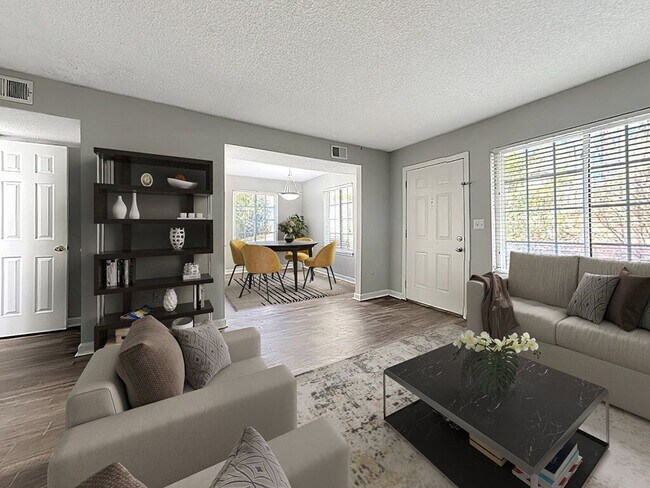 Amplia sala de estar con pisos estilo madera - West Winds Townhomes