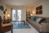Located at 8044 Gleason Dr in Knoxville, Tennessee, this single-floor residence offers a well-organized layout designed for comfortable everyday living. The living room serves as the heart of the home, featuring neutral walls, plush carpeting, and a set of French doors that open to a private outdoor area, filling the space with natural light and providing seamless indoor-outdoor connectivity. The room offers ample space for seating and entertaining.

Adjacent to the living area, the dining room is a cozy, defined space equipped with a ceiling fan and room for a full dining set, making it ideal for meals and gatherings. It connects directly to the galley-style kitchen, which features white cabinetry, tile flooring, and generous counter space — a practical and efficient layout for home cooking.

The bedroom is a calm, restful retreat with soft carpeting, a ceiling fan, and a window dressed with navy curtains that allow for both natural light and privacy. The bathroom features tile flooring, a shower/tub combination, and a vanity with ample counter space, completing the functional design of this residence.

Throughout the home, warm neutral tones and consistent finishes create a cohesive and inviting atmosphere, making this Knoxville property a well-rounded and practical living space.