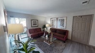 This single-story residence at 4927 Wild Holly Ln in Arlington, TX offers a well-organized layout across several distinct living spaces. The living room serves as the central gathering area, featuring wood-look flooring, a textured ceiling, and a sliding glass door that opens to an outdoor patio, allowing natural light to fill the space and providing a seamless indoor-outdoor connection.

The kitchen is equipped with dark espresso cabinetry, a granite-style countertop, a double stainless steel sink, a dishwasher, and a decorative mosaic tile backsplash that adds visual interest. A pantry or storage closet is conveniently accessible from the kitchen area.

The two bedrooms are carpeted and each features windows with blinds that allow for natural light and outdoor views. Ceiling fans are present in the bedrooms, contributing to comfort year-round. Both rooms include closet storage.

The two bathrooms each feature a tub-shower combination, vanity with a light countertop surface, a mirror, and textured ceilings. The overall design of the unit maintains a neutral color palette throughout, creating a cohesive and functional living environment suited for everyday use.