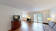 Located at 10213 W 34th St in Minnetonka, MN, this well-appointed one-bedroom, one-bathroom unit offers a comfortable and functional layout across a single floor. Warm wood-look flooring flows throughout the space, creating a cohesive and inviting atmosphere.

The living room is open and airy, filled with natural light from large sliding glass doors that lead to a private balcony overlooking lush greenery. The space is well-proportioned, offering plenty of room for both relaxing and working from home.

The galley-style kitchen is thoughtfully designed with white shaker cabinets, granite-look countertops, and stainless steel appliances including an electric range, refrigerator, and dishwasher. A double sink and ample cabinetry provide practical storage and prep space.

The spacious primary bedroom accommodates a full-sized bed comfortably and benefits from multiple windows that bring in soft natural light. The room features neutral walls and the same wood-look flooring, contributing to the unit's clean, modern aesthetic.

The bathroom has been tastefully updated with large-format grey tile on both the floors and tub surround, complemented by a white vanity with modern hardware and a full tub-shower combination. The overall design is crisp and contemporary, making this unit a polished and practical Minnetonka residence.