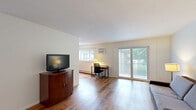 Located at 10213 W 34th St in Minnetonka, MN, this well-appointed one-bedroom, one-bathroom unit offers a comfortable and functional layout across a single floor. Warm wood-look flooring flows throughout the space, creating a cohesive and inviting atmosphere.

The living room is open and airy, filled with natural light from large sliding glass doors that lead to a private balcony overlooking lush greenery. The space is well-proportioned, offering plenty of room for both relaxing and working from home.

The galley-style kitchen is thoughtfully designed with white shaker cabinets, granite-look countertops, and stainless steel appliances including an electric range, refrigerator, and dishwasher. A double sink and ample cabinetry provide practical storage and prep space.

The spacious primary bedroom accommodates a full-sized bed comfortably and benefits from multiple windows that bring in soft natural light. The room features neutral walls and the same wood-look flooring, contributing to the unit's clean, modern aesthetic.

The bathroom has been tastefully updated with large-format grey tile on both the floors and tub surround, complemented by a white vanity with modern hardware and a full tub-shower combination. The overall design is crisp and contemporary, making this unit a polished and practical Minnetonka residence.