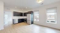 Located on the fourth floor at 22 Schuyler Pl in downtown Morristown, NJ, Unit 403 is a modern 2-bedroom, 3-bathroom residence offering a thoughtfully designed open-concept layout with clean, contemporary finishes throughout. Light wood-look flooring flows seamlessly across the entire unit, creating a bright and cohesive aesthetic.

The open living and dining area connects directly to a well-appointed kitchen featuring dark matte cabinetry with gold hardware, white subway tile backsplash, light countertops, and a full suite of stainless steel appliances including a gas range, built-in microwave, French door refrigerator, and dishwasher. Multiple windows invite natural light and offer views of the surrounding Morristown streetscape.

The spacious primary bedroom includes dual windows with roller shades and a closet. The second bedroom features a built-in shelved closet and its own window with urban views. Both rooms are finished with the same light flooring and crisp white walls.

The three bathrooms offer distinct configurations: one includes a soaking tub with large-format tile surround, while another features a glass-enclosed walk-in shower with hexagonal mosaic floor tile and subway wall tile. The unit's clean, modern design is consistent throughout, making it a polished and functional residence in the heart of Morristown.