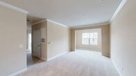 Located at 201 Sandbar Cir in Greensboro, NC, this well-appointed single-floor home offers three bedrooms and two bathrooms within a comfortable and efficiently designed layout. The open-concept living and dining area is finished with plush wall-to-wall carpeting and elegant crown molding, creating a clean and inviting atmosphere. Natural light flows in through large windows, enhancing the warm, neutral color palette that carries throughout the home. The kitchen features rich wood cabinetry, light granite-style countertops, a breakfast bar peninsula, and wood-look flooring, with black appliances including a refrigerator, range, and dishwasher providing a modern contrast. The spacious primary bedroom is highlighted by crown molding and a large window with outdoor views. The additional bedrooms are carpeted and bright, each with windows that bring in natural light and views of the surrounding area — one featuring a ceiling fan for added comfort. Both bathrooms are finished with wood-look flooring, dark wood vanities with light countertops, and well-lit mirrors. The second bathroom includes a full tub-shower combo. A hallway and closet complete the functional layout, making this a practical and comfortable home in Greensboro.