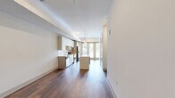 Located at 9 City Place in Nashville, Tennessee, this one-bedroom, one-bathroom residence offers a thoughtfully designed open-concept layout with modern finishes throughout. Rich hardwood flooring flows across the main living areas, anchoring the space with warmth and continuity.

The kitchen is a standout feature, showcasing sleek flat-front cabinetry in a light wood tone, stainless steel appliances including a refrigerator, range, and microwave, and a crisp white quartz countertop. A central island with built-in shelving provides additional prep space and storage, while pendant lighting above adds a refined touch. Large glass doors at the far end of the kitchen invite natural light and offer access to an outdoor balcony.

The bedroom is a calm, carpeted retreat with neutral walls, a ceiling fan, and a dedicated nook with a window framing greenery views. A spacious walk-in closet with wire shelving and hanging rods provides generous storage.

The bathroom is clean and contemporary, featuring a long vanity with white quartz countertops, light wood cabinetry, brushed nickel fixtures, and tile accent walls. The layout is efficient, with a separate toilet area for added privacy.

This well-appointed residence combines modern design with functional living in a desirable Nashville location.