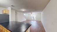 This Cambridge Woods townhome offers 1,070 square feet of living space across two floors. The layout comprises 2 bedrooms, 3 bathrooms, and an open-concept kitchen and living area. The primary bedroom is generously sized at 170 square feet.

The ground floor spans 560 square feet and includes the main living areas. The kitchen features wooden cabinetry, black countertops, and stainless steel appliances, with a convenient breakfast bar. The living room is spacious and bright, with hardwood flooring and a ceiling fan for comfort.

Upstairs, the 520-square-foot second floor houses the bedrooms and additional bathrooms. Both bedrooms are well-proportioned with hardwood floors and ceiling fans. The bathrooms are fitted with modern fixtures, including a bathtub in at least one.

Throughout the home, large windows allow for ample natural light, enhancing the sense of space. The property also includes an in-unit laundry room with full-sized appliances, adding convenience to daily life.

The townhome's neutral color palette and clean lines create a contemporary feel, while the hardwood floors add warmth and character. With its thoughtful layout and modern amenities, this townhome offers a comfortable and practical living space in the desirable Cambridge Woods community.