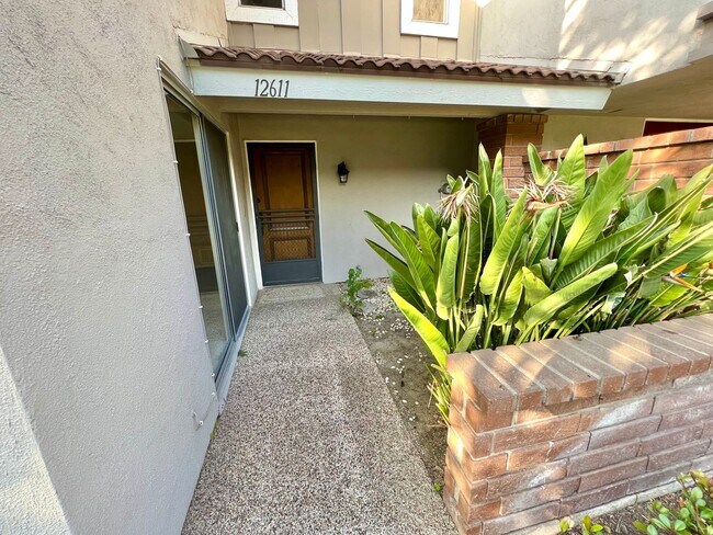 Building Photo - Lush grounds surround this townhouse in a ...