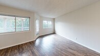 Located at 7450 MN-7 W in St. Louis Park, MN, this one-bedroom, one-bathroom unit offers a practical and well-designed single-floor layout. The living room is bright and open, featuring durable wood-look flooring, neutral-toned walls, and multiple windows that invite natural light and provide views of surrounding greenery. A door from the living area offers direct outdoor access, enhancing the connection to the exterior.

The kitchen is efficiently arranged with white cabinetry, stainless steel appliances including a refrigerator, electric range, and microwave, and light wood-look flooring that carries through from the main living area. A closet adjacent to the kitchen houses in-unit laundry, adding notable convenience.

The bedroom is a comfortable, well-proportioned space finished with plush carpeting and a window that allows natural light to filter in. A hallway connects the main living areas to the bedroom and bathroom, providing a clear and functional flow throughout the unit.

The bathroom features a dark-cabinet vanity with a light countertop, a large mirror, brushed nickel fixtures, and tiled flooring, offering a clean, updated aesthetic. Throughout the unit, a consistent use of neutral tones and modern finishes creates a cohesive and move-in-ready living environment.