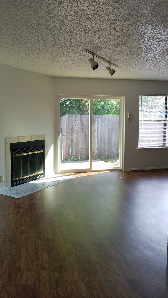 Living Room with WBFP and Privacy Fenced Patio - 7636 John T White Rd