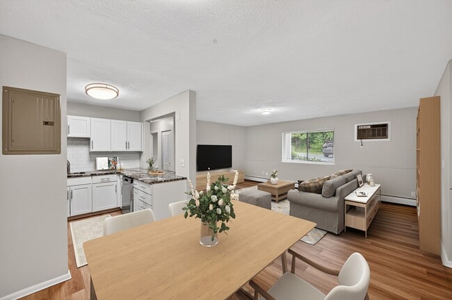 Inviting and modern, Park Village West features beautifully designed living spaces that blend comfort with style. The open layout showcases a spacious kitchen and cozy living area, perfect for gatherings. Explore your new home today! - Park Village West