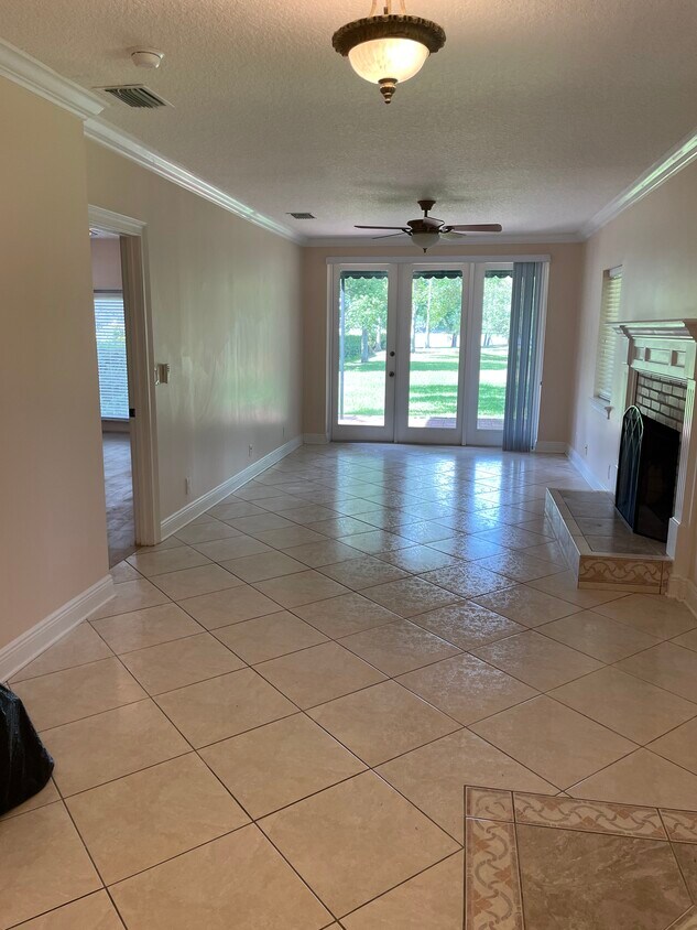 Living room area with lake view and fireplace - 3005 W Sligh Ave