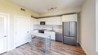 Located on the third floor at 500 N Andrews Ave in Fort Lauderdale, FL, this well-appointed one-bedroom, one-bathroom unit offers a thoughtfully designed layout with modern finishes throughout. Wood-style flooring flows consistently across the living areas and bedroom, creating a warm and cohesive aesthetic.

The kitchen is a standout feature, showcasing flat-panel white cabinetry that extends to the ceiling for ample storage, a marble-style subway tile backsplash, and a full suite of stainless steel appliances including a French door refrigerator, electric range, built-in microwave, and dishwasher. Light-toned countertops and a mobile island add functionality to the space.

The bedroom offers a comfortable and quiet retreat with clean white walls and direct access to the bathroom, which features marble-style tile surrounding a soaking tub and shower combination, white vanity cabinetry, and tile flooring. A dedicated closet provides practical storage, complete with a built-in shelf.

The overall design reflects a clean, contemporary style with a neutral color palette, recessed and track lighting, and consistent use of quality materials. This unit is ideal for those seeking a modern, low-maintenance living space in the heart of Fort Lauderdale.