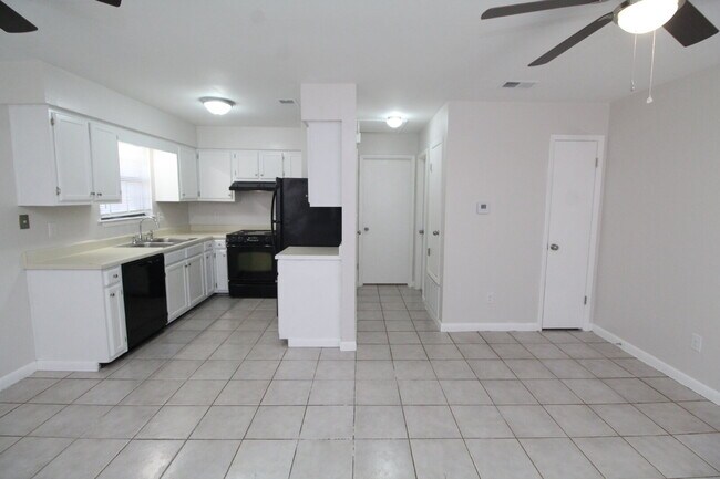 Building Photo - 1BR Townhome with Private Fenced Backyard & Tile Flooring Throughout