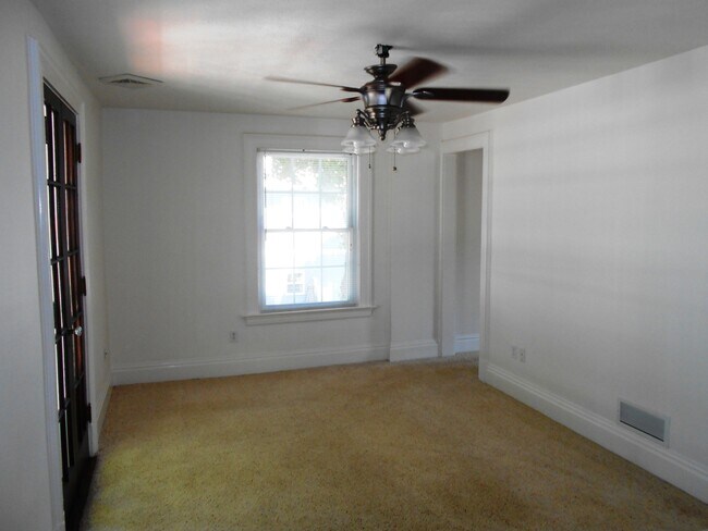 Living room with french doors to outdoor balcony - 2502 Powell Ave