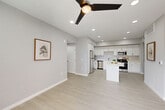 Located at 1349 Blossom Ave in Suisun City, CA, this well-designed single-story home offers three bedrooms and three bathrooms across a thoughtfully organized floor plan. The open-concept living, dining, and kitchen area serves as the heart of the home, bathed in recessed lighting and finished with light wood-look flooring. A ceiling fan adds a practical touch to the living space. The kitchen is a standout feature, showcasing crisp white shaker cabinetry, sleek light countertops, a central island, and a full suite of stainless steel appliances including a gas range, microwave, refrigerator, and dishwasher. The bathrooms maintain the home's clean aesthetic with white vanities, tub-shower combinations, and light flooring. Each of the three bedrooms is finished with plush carpeting, ceiling fans, and windows that allow natural light to filter in. Closets throughout the home are outfitted with built-in shelving and hanging rods for organized storage. Additional spaces include a dedicated laundry area, a utility room, a patio for outdoor enjoyment, and a welcoming entrance. The overall ambiance is bright, modern, and move-in ready.
