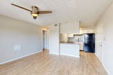 Located at 3595 Misty Oak Drive in Melbourne, FL, this one-bedroom, one-bathroom residence offers a well-designed layout across a single floor. The open-concept living, dining, and kitchen area forms the heart of the home, finished with light wood-style flooring and a textured ceiling with a ceiling fan that keeps the space comfortable year-round. Large windows flood the living area with natural light, and a door leads directly to a private balcony, extending the living space outdoors.

The kitchen is a functional highlight, featuring granite countertops, white cabinetry, a subway tile backsplash, a coil-top range, and a full-size black refrigerator. A peninsula counter provides additional prep space and a casual dining option, seamlessly connecting the kitchen to the living and dining area.

The bedroom is carpeted for warmth and comfort, includes a ceiling fan, and benefits from a window with natural light. A dedicated closet provides ample storage. The full bathroom is clean and bright, featuring a tub-shower combination with white tile surround. Additional conveniences include a dedicated laundry area and a utility room, rounding out this efficient and practical Melbourne residence.