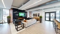 The Aura Lounge, located at 2016 Linkway Blvd in London, Ontario, is a meticulously designed single-story space spanning 1000 square feet. The interior showcases a harmonious blend of contemporary aesthetics and functional design. The centerpiece is an elegant conference room, furnished with a long wooden table and comfortable olive-green chairs, illuminated by striking globe pendant lights. Adjacent to this is a modern lounge area, featuring plush seating arrangements around a sleek fireplace and large-screen display.

The space boasts an open floor plan with high ceilings and expansive windows, allowing abundant natural light to flood the interior. Light wood flooring runs throughout, complementing the crisp white walls adorned with abstract artwork. A well-organized shelving unit provides both storage and display options. The entryway features glass partitions and wooden sliding doors, maintaining an airy feel while offering privacy when needed.

Attention to detail is evident in the carefully curated lighting fixtures, from the statement pendant lights to the recessed ceiling lights, creating a warm and inviting atmosphere. The cohesive design palette of neutrals with pops of color in the furnishings and artwork contributes to the space's sophisticated ambiance, making it ideal for professional meetings, social gatherings, or creative collaborations.