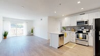 Located in the Hollywood Hills area of Los Angeles, this well-appointed 1-bedroom, 1-bathroom unit offers a thoughtfully designed single-floor layout with a clean, modern aesthetic throughout. Light-toned hardwood-style flooring runs seamlessly across the entire space, complementing the crisp white walls and recessed lighting that give every room a bright, airy feel.

The open-concept kitchen and dining area serves as the heart of the home, featuring white shaker-style cabinetry, a gray tile backsplash, quartz countertops, a peninsula with an undermount sink, and a full suite of stainless steel appliances. A small built-in nook near the kitchen provides additional counter space, ideal for a home office setup or beverage station.

The spacious living room flows naturally from the kitchen and dining area, bathed in natural light from a large sliding door that opens onto a private balcony. The bedroom is generously sized with corner windows that frame views of the surrounding hillside, filling the room with abundant natural light. Two closets, including a walk-in with dual hanging rods, provide ample storage.

The bathroom is finished in a clean, contemporary style with white cabinetry, quartz countertops, a large vanity mirror, and a separate shower. In-unit laundry adds everyday convenience to this well-rounded Los Angeles residence.