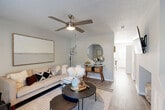 Located in Concord, NC, this two-story, 2-bedroom, 2-bathroom home offers a well-designed layout spread across two floors. The main level features a bright and welcoming living room with hardwood-style flooring, a ceiling fan, and a fireplace — an ideal space for relaxing or entertaining. The kitchen is thoughtfully updated with gray shaker-style cabinetry, a subway tile backsplash, light quartz countertops, black appliances, and a double sink. A dedicated dining area adjacent to the kitchen benefits from natural light through a window, making it a comfortable everyday gathering spot. A staircase with carpet treads connects the two levels. Upstairs, the spacious primary bedroom offers plush carpeting and generous proportions, while the second bedroom is a cozy, versatile space with a window for natural light and carpet flooring. Both bathrooms are finished with gray vanities, white countertops, and brushed nickel fixtures; one features a full tub-shower combination. Neutral tones and consistent finishes throughout create a cohesive, modern aesthetic that is both functional and inviting.