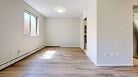 Located at 30 Campbell Court in Stratford, Ontario, this 2-bedroom, 1-bathroom unit offers a practical and well-organized single-floor layout. The combined kitchen and living area forms the heart of the unit, with the kitchen featuring white upper and lower cabinetry, light stone-look countertops, and a full suite of stainless steel appliances including a refrigerator, electric range, built-in microwave, and dishwasher. Light tile flooring runs through the kitchen, while the living area is finished with laminate wood-look flooring that extends throughout the rest of the unit. The living room benefits from a sliding glass door that invites natural light and provides an outdoor view. Both bedrooms are comfortably sized, with the primary bedroom offering a window with a wooded view and a double-door closet for ample storage. The second bedroom also includes a double-door closet and connects conveniently to the hallway. The bathroom is finished with slate-style tile flooring, a full bathtub with shower, and a white vanity with stone-look countertop. A hallway connects all rooms efficiently, completing this clean and functional layout.