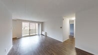 Located at 801 Cooper Landing Rd in Cherry Hill, New Jersey, this single-floor residence offers a clean, modern aesthetic throughout its thoughtfully designed layout. The spacious living area is highlighted by rich hardwood-style flooring, crisp white walls, and abundant natural light streaming through large sliding glass doors that open onto a private balcony with outdoor views. The open flow between the living and dining areas creates a generous, airy feel well-suited for everyday living and entertaining.

The galley-style kitchen is a standout feature, outfitted with dark espresso cabinetry, light stone-look countertops, a subway tile backsplash, stainless steel appliances including a refrigerator and dishwasher, and hardwood-style flooring that ties seamlessly into the living spaces.

The bedrooms are comfortably sized and finished with plush gray carpeting and individual windows that bring in natural light and outdoor views. The bathroom is well-appointed with a full soaking tub and shower combination, accented by classic white subway tile and a decorative mosaic tile border, adding a refined touch to the space.

Throughout the residence, neutral tones and consistent finishes create a cohesive, move-in-ready environment in this Cherry Hill community.