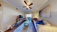 Located at 9745 Grand Teton Dr in Las Vegas, NV, this well-appointed 2-bedroom, 2-bathroom residence offers a comfortable and functional single-floor layout. The open-concept living, dining, and kitchen area forms the heart of the home, featuring warm wood-style flooring, crown molding, and a ceiling fan that add a polished touch throughout. The living room is bright and inviting, with sliding glass door access to a private patio. The kitchen is equipped with stainless steel appliances, including a gas range, microwave, and refrigerator, complemented by rich wood cabinetry and granite-style countertops. A dedicated pantry provides additional storage. The dining area accommodates intimate gatherings and benefits from the same refined trim details seen throughout the space. Both bedrooms are comfortably sized, with the primary bedroom featuring a walk-in closet and natural light from a large window. Each bathroom includes a tub-shower combination, wood-style flooring, and granite-topped vanities with wood cabinetry. Additional conveniences include an in-unit laundry area, two hallways for smooth circulation, and two closets for ample storage. The private patio rounds out this well-designed residence.