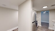 Located at 741 Barcelona Ct in Birmingham, Alabama, this single-floor residence offers a thoughtfully updated interior with a clean, modern aesthetic throughout. The galley-style kitchen is a standout feature, showcasing crisp white shaker cabinetry extending to the ceiling, granite countertops, stainless steel appliances including a refrigerator and range, a stainless undermount sink, and durable wood-look plank flooring. The layout opens toward the living areas, which are finished with the same wood-look flooring and neutral warm-toned walls, creating a bright and cohesive feel. A ceiling fan is present in the living area, enhancing comfort. The living space benefits from a sliding glass door that invites natural light and outdoor views. Bedrooms are finished with plush carpeting and feature windows with views of surrounding greenery, providing a quiet retreat. The bathrooms are well-appointed with granite-topped white vanities, wood-look plank flooring, and clean white fixtures. Closet space with wire shelving provides practical storage. Throughout the unit, consistent white baseboards, neutral paint tones, and modern hardware tie the design together into a polished, move-in-ready residence.