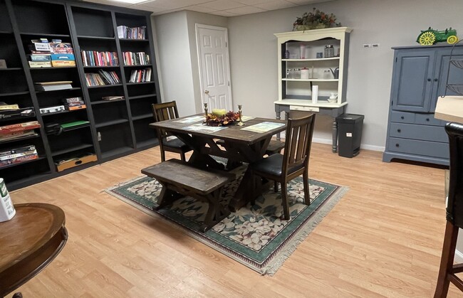 Open Floor Plan Dining Room with high wall shelves stocked with games and puzzles - 1253 Davis Rd W