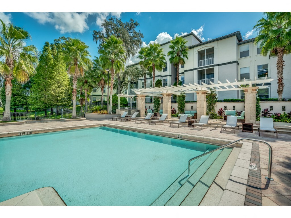 Pool area with lounge seating and umbrellas - Sanctuary at Highland Oaks
